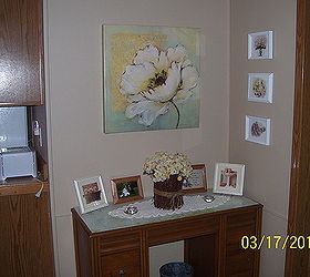 before and after redo with ashley cole mobile home kitchen remake, home decor, kitchen design, The formerly frightening floral has been banished by a couple coats of paint and the antique desk works The small white florals were made by taking old gold frames painting them stark white and putting pictures from a book in them