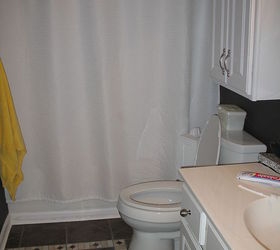 from playful kid s bathroom to sophisticated adult teen bathroom on a budget not, bathroom ideas, diy, home decor, Almost done after Still some work to be done but new floor is in New toilet new curtain
