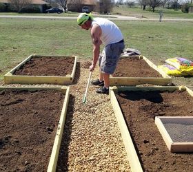 raised bed garden part 3 dirt and planting, diy, gardening, how to, raised garden beds, Spreading the pebbles in the pathways with a rake