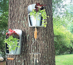 repurposed junk garden, gardening, repurposing upcycling, Feed grain scoops again with MWHP s idea of placing them on the tree with our favorite wind chimes we made from flattened spoons and vintage kitchen tools they sound so very pretty