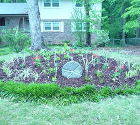 getting things ready for spring, gardening, This looks sort of pitiful now Hee hee but it will fill in Hubby anchored my MILL WHEEL so no one would take it