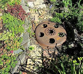 using salvaged brick in the flower border, flowers, gardening, repurposing upcycling, Interesting metal junk is included in the brick path