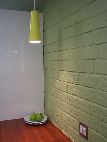 We stripped the plaster off the exterior wall to give the kitchen this industrial feel.
