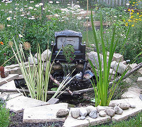 easy waterfall using a household item, gardening, ponds water features, repurposing upcycling, It s amazing how much livelier a garden seems with the sound of running water See my blog for everything you need to know to start a little pond and waterfall in your garden