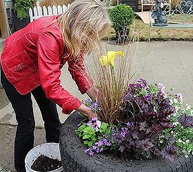 up cycled tire planter, container gardening, flowers, gardening, perennials, repurposing upcycling, Step 6 Fill in with soil between the newly transplanted pots and water in generously