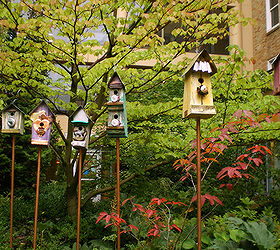 placing birdhouses in the garden, flowers, gardening, Multiple birdhouses can add a splash of color and depth to your garden You must make sure the birds that would reside in this type of house will get along though No one wants a feathered quarrel