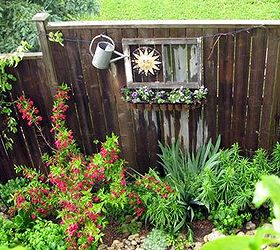 little city garden before and afters, flowers, gardening, perennials, ponds water features, raised garden beds, urban living, Year 4 The old tools were replaced by some garden art and a pink weigela adds colour when the orange lilies are not in bloom