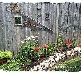 little city garden before and afters, flowers, gardening, perennials, ponds water features, raised garden beds, urban living, Year 2 I started putting my broken tools and mirrors on the fence to create a fun focal point above the orange lilies
