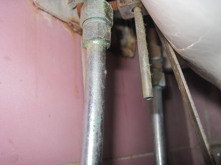 how do i fix this leak this part of the sink s plumbing is leaking see photo, bathroom ideas, home maintenance repairs, how to, kitchen design, plumbing, Water is dripping from the small hollow pipe that you see in the middle of the photo