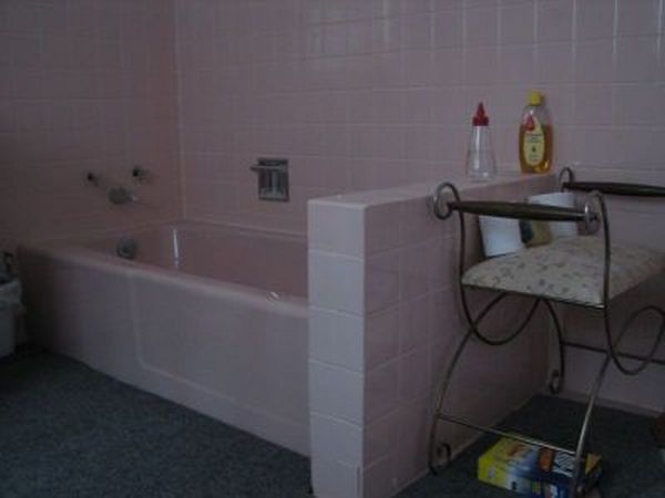 pink is evil according to my husband, bathroom ideas, tiling, the old bath tub Must have weight 300 pounds because it was cast iron The little partition on the end was a puzzle to me Why would someone put this there