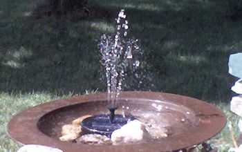 Copper birdbath on wrot iron stand $10 - Floating solar fountain $25 -- Brass spittoon $1.