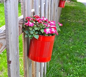 upcycling cans to diy hanging fence planters, flowers, gardening, outdoor living, repurposing upcycling, Blooms in my bright red upcycled pots