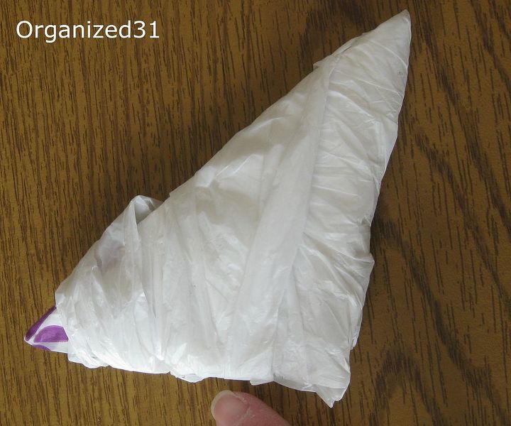 how to fold plastic shopping bags to take up less space, cleaning tips, You end up with a compact and neatly folded triangle football You ll be surprised how much less room your plastic bags will take up when folded this way