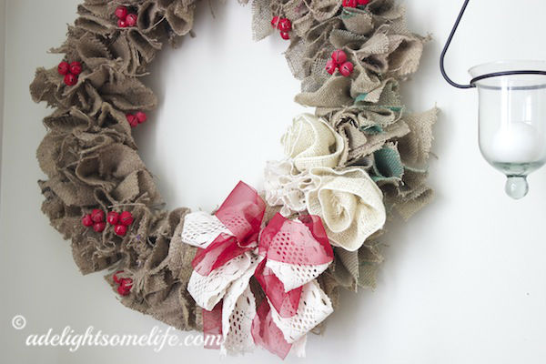how to make a burlap christmas wreath from coffee sacks, christmas decorations, crafts, seasonal holiday decor, wreaths, Wreath made from strips of burlap from coffee sack and embellished with red jingle bells and ribbon