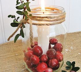 fun and easy christmas mason jar candles, christmas decorations, seasonal holiday decor, Just anchor a candle inside a Mason jar using candle wax or wax buttons Then add fresh cranberries and wrap jute twine around the rim Add a sprig of boxwood for a festive touch