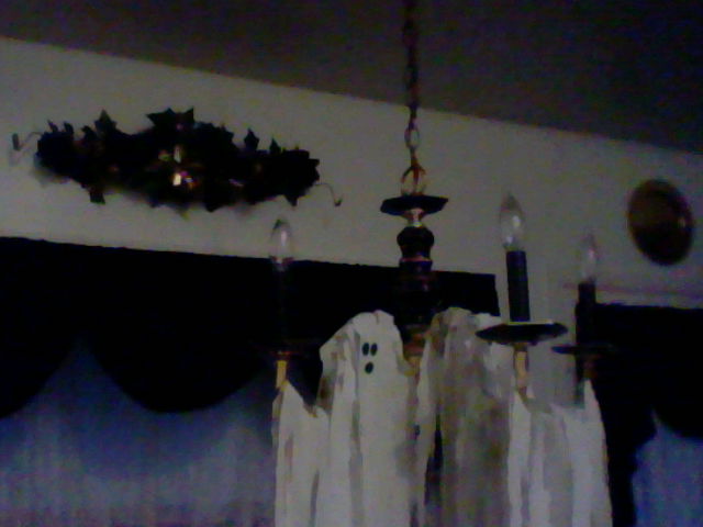 halloween decorating with black and white, halloween decorations, seasonal holiday d cor, wreaths, Ghost Chandelier white sheet strips It looks like the ghost is peeking out and holding a candle