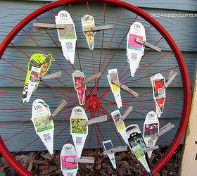 bike wheel plant label tag organizer, flowers, gardening, repurposing upcycling, I used an old bike wheel that had been spray painted red The same wheel I used on my Christmas mantel on Hometalk
