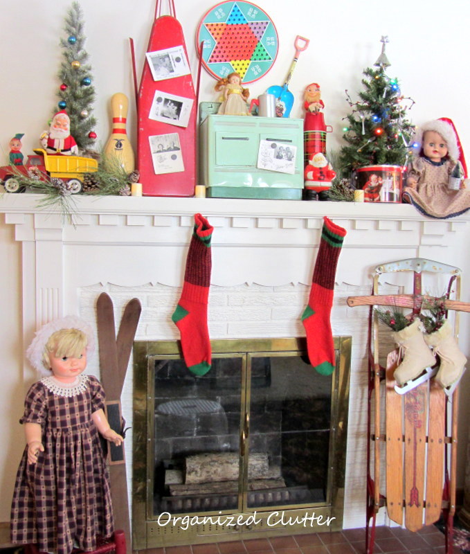 vintage toys on the christmas mantel, christmas decorations, seasonal holiday decor, Wool socks sled and skis below the mantel