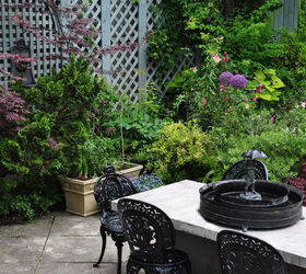a romantic garden in the heart of the city, gardening, Dining area with a small table fountain