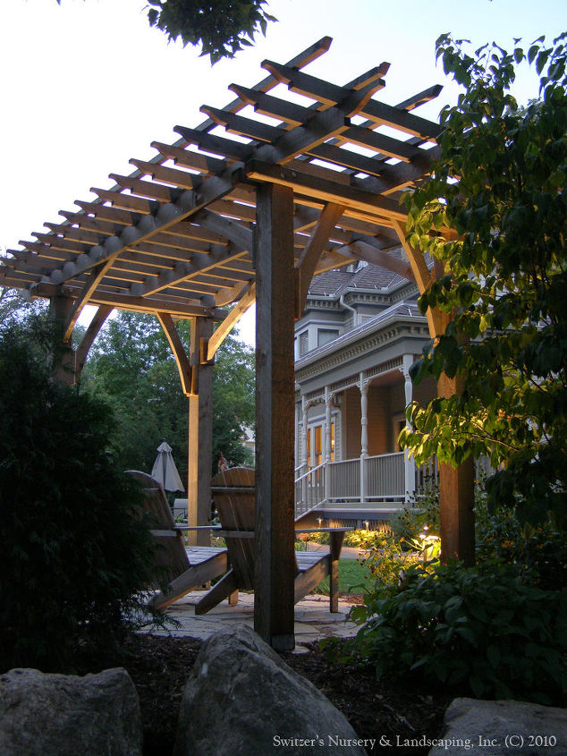 custom arbors amp pergolas by switzer s, outdoor living, Cedar pergola in the back corner of this historic home provides a wonderful oasis from the daily grind sit back with a glass of wine in the Adirondack chair and relax