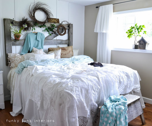 A gate and sawhorse meant for outdoors share a life together indoors these days. The bedding was created by throwing loose linens on top of a quilt. Sheets were tucked in between the mattresses for a full length look.
How to is at:
http://www.funkyjunkinteriors.net/2012/05/how-to-decorate-bedroom-with-messy.html