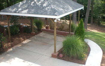 Build carport over parking pad and add concrete walkway