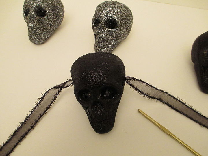 super easy dollar tree glitter skull garland, crafts, halloween decorations, seasonal holiday decor, Pull the ribbon all the way through to the other side