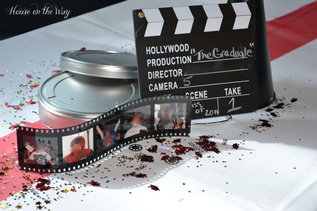 graduation party idea a movie themed graduation party, crafts, The centerpieces consisted of silver metal movie reel cases clapboards filmstrip photo frames and director megaphones Graduation and movie confetti were sprinkled on the tables