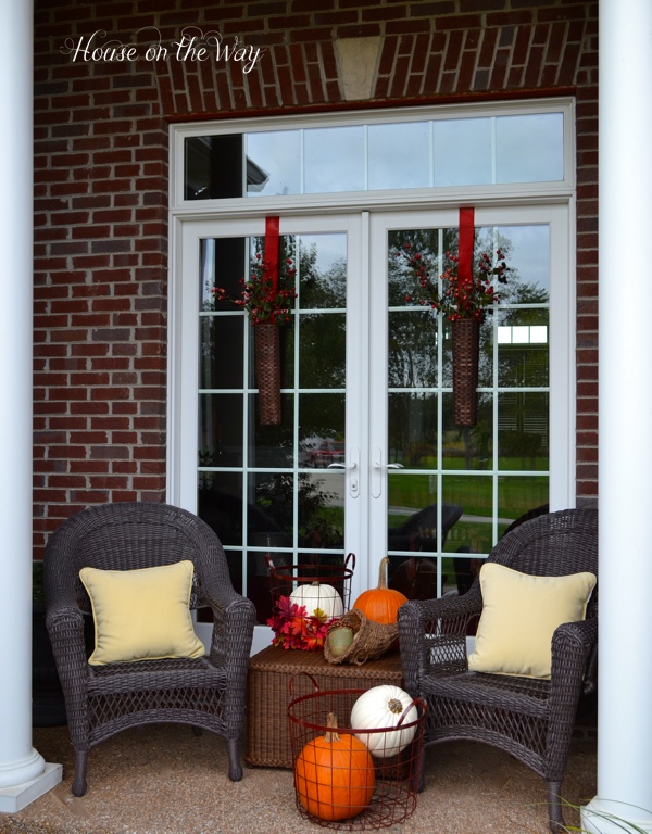 fall porch tour, porches, seasonal holiday decor, wreaths, For my covered porch I used two all weather wicker chairs and coffee table I filled the area with pumpkins leaves and lots of Fall colors
