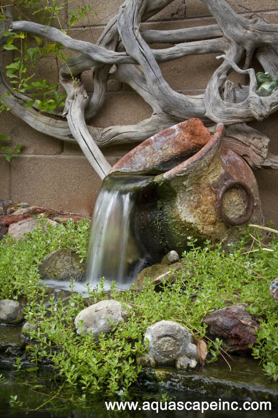 fountains in the garden, outdoor living, ponds water features, A rustic urn flows beneath dramatic driftwood art