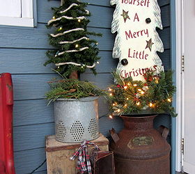 a christmas pew for the patio, christmas decorations, seasonal holiday decor, wreaths, I also added an alpine tree on a vintage minnow bucket insert I plant flowers in it in the summertime Another wooden lighted tree milk can crate and Victorian ice skates round out the front patio vignette