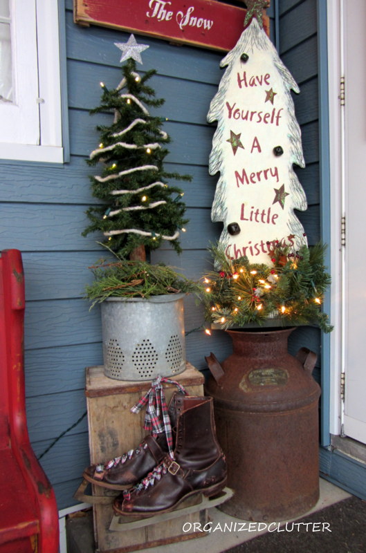 a christmas pew for the patio, christmas decorations, seasonal holiday decor, wreaths, I also added an alpine tree on a vintage minnow bucket insert I plant flowers in it in the summertime Another wooden lighted tree milk can crate and Victorian ice skates round out the front patio vignette