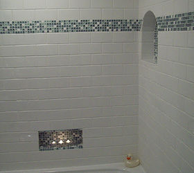 spa blue bathroom makeover on a budget, bathroom ideas, home improvement, tiling, I used white subway tile with a small band of glass mosaic tile and two niches The lower niche was placed off center and low so it can be reached when taking a bath and it works wonderfully