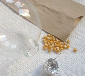 a magical christmas ornament, christmas decorations, seasonal holiday decor, Add 1 TBSP popcorn kernels into a GLASS ornament ball it can t be plastic you ll see why in a minute