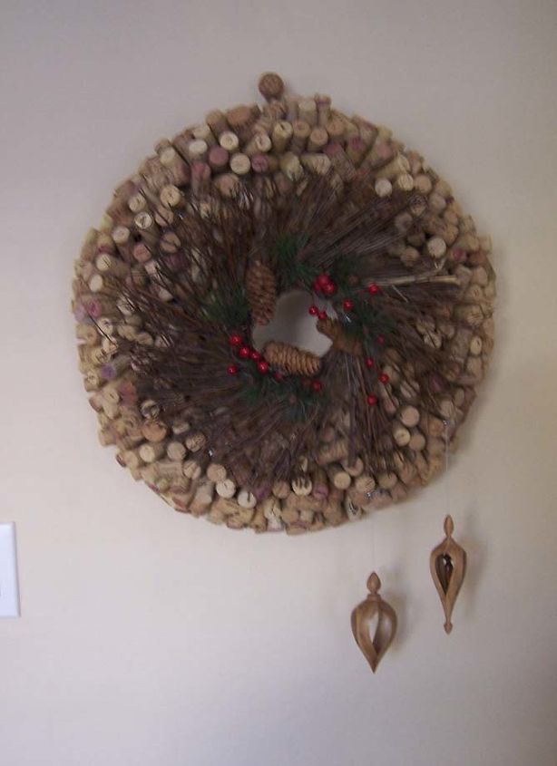 diy cork wreath, crafts, seasonal holiday decor, wreaths, My 1 000 wine cork wreath made from corks wreath form Dollar store twig wreath in front two hand crafted wooden ornaments I had