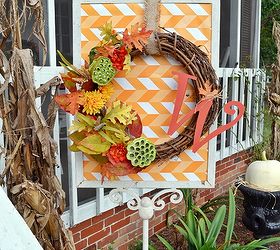 a country cottage s fall porch tour, decks, porches, seasonal holiday decor, wreaths, This wreath hangs on a stand outside of the porch