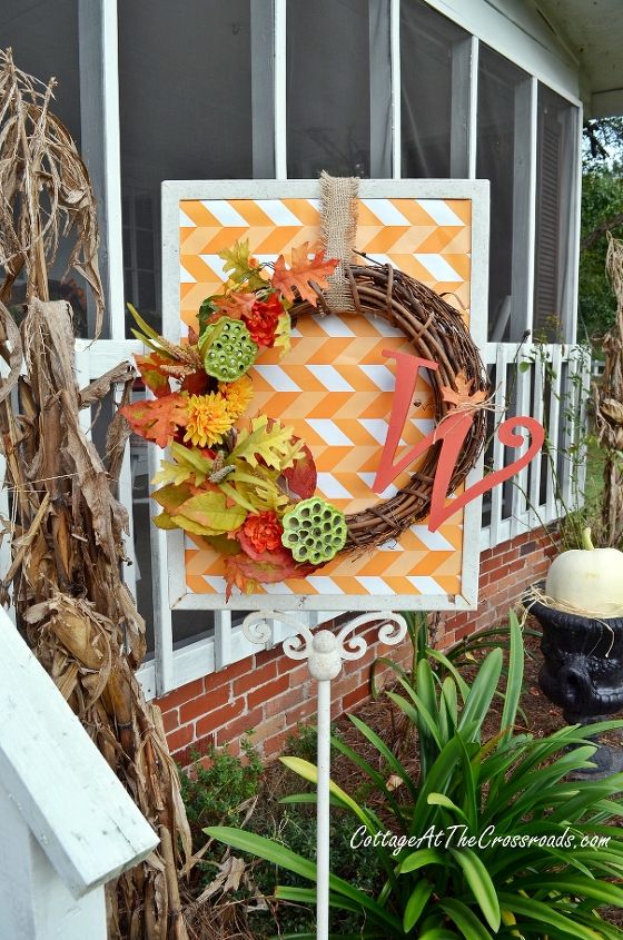 a country cottage s fall porch tour, decks, porches, seasonal holiday decor, wreaths, This wreath hangs on a stand outside of the porch