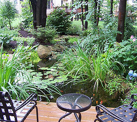 create a tropical dining spot in your backyard, decks, gardening, outdoor living, patio, ponds water features, Lush plants add to the tropical feel of this deck and pond