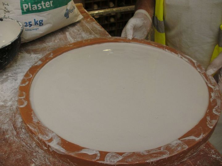 how to make a ceiling rose, The flood mould is carefully vibrated to remove any air pockets and to make sure that all the enrichments are fully covered