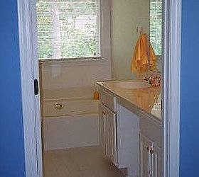 master bathroom makeover on a budget, bathroom ideas, home decor, BEFORE prefab countertop in builder beige builder beige walls gold fixtures and the giant lightbulb fixture and white tile floor with gross stained grout