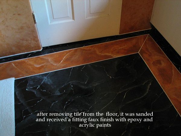 Last but not least the pink tile was removed from the floor. It has spots where the tile was loose or cracked. Beneath a plywood floor. I sanded this with a belt sander and I'll never use such heavy equipment again, I'll tell you. But after that the floor was done with the same epoxy marbled and framed with tile look faux finish. It's lasting and lasting. This bathroom is now 2 years old.
