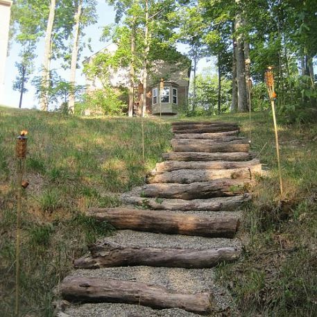 creating a creek stone patio fire pit, The stairs were made with fallen trees gravel placed where the ground naturally stepped down