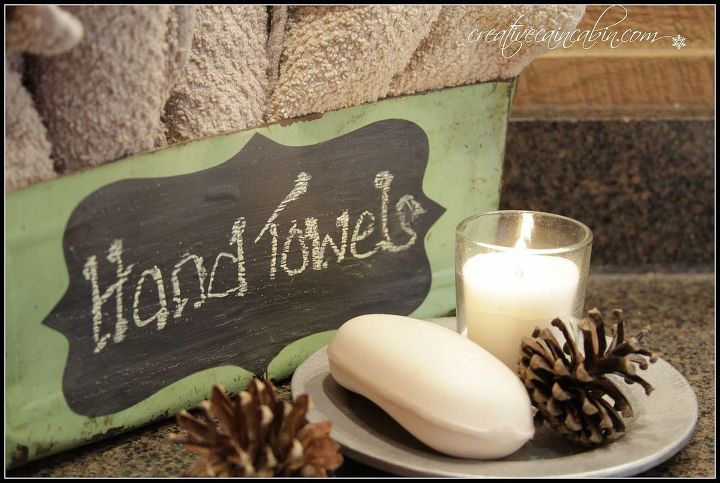 turn a vintage dustpan into a bathroom hand towel station, repurposing upcycling