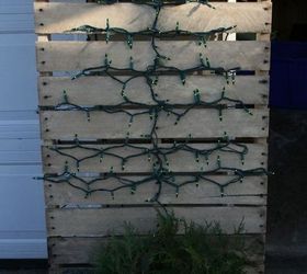 my outdoor decor this year, christmas decorations, repurposing upcycling, seasonal holiday decor, I stapled some green lights in the shape of a tree onto this pallet so that I would have a light up pallet tree and could continue to use the pallet without taking it apart