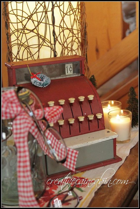 woody pillow and a vintage cash register, seasonal holiday decor