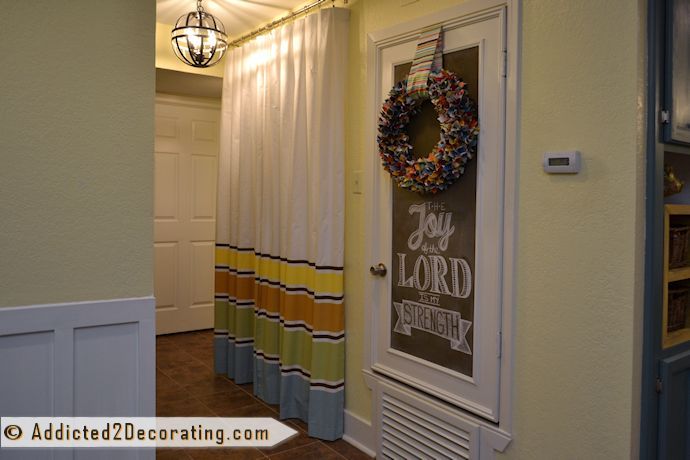 tiny condo laundry room disguised as a hallway, foyer, laundry rooms, Washer dryer closet with inexpensive curtains painted with latex paint and the HVAC door dressed up with trim and chalkboard paint