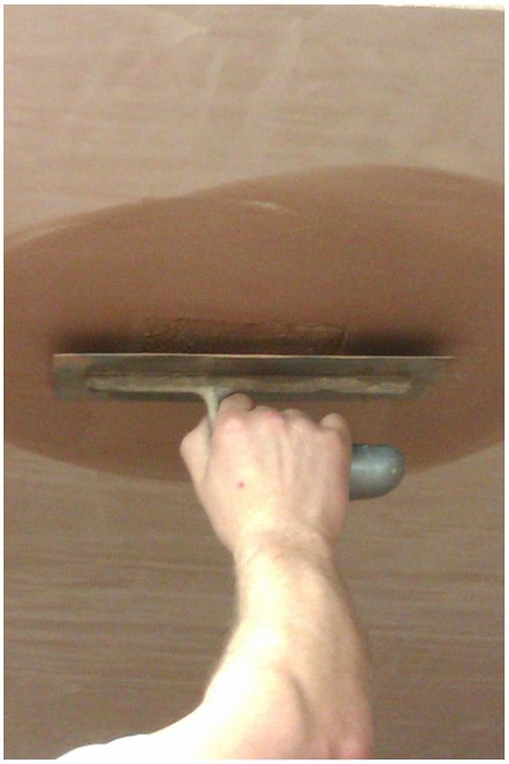 how to repair a small hole in your ceiling, The finishing plaster is then applied and trowel to a smooth surface and marrying in the edges of the patch all surplus plaster is washed off during the application