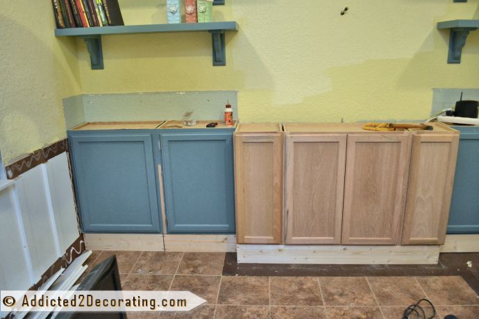 diy bookcase media wall, diy, painted furniture, shelving ideas, woodworking projects, I used stock wall cabinets 12 deep from Home Depot as lower cabinets so I had to build a base for them I was reusing some cabinets from a previous media wall attempt that didn t turn out so great which is why they re painted