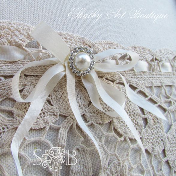 a little bit of granny chic, crafts, home decor, repurposing upcycling, A large vintage doily was attached to the base board as a pocket and finished off with a lovely rhinestone button and silk ribbons