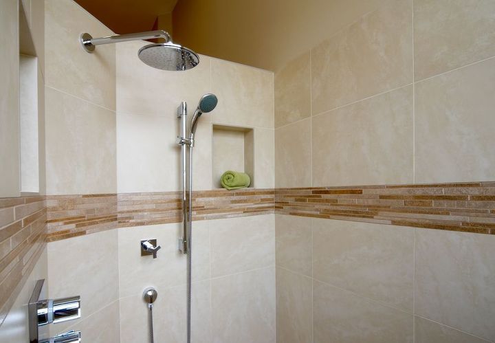 our homeowners expressed a desire to change their early 90 s inspired pink bathroom, bathroom ideas, home decor, The small shower was given a complete upgrade as well A new walk in shower complete with glass accent tiles and rain shower shower head replaced the outdated cultured marble shower with gold framed glass shower door